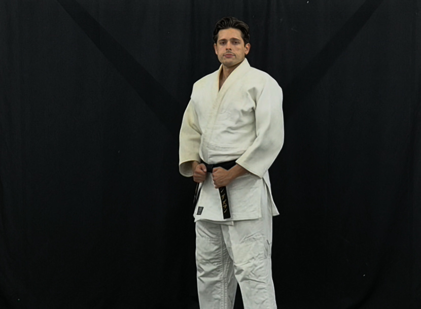 Kodokan Judo instructor in white judogi standing posture