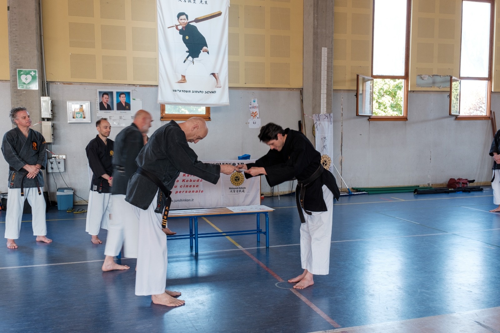 Instructor practicing Matayoshi Kobudo with sensei at a traditional seminar
