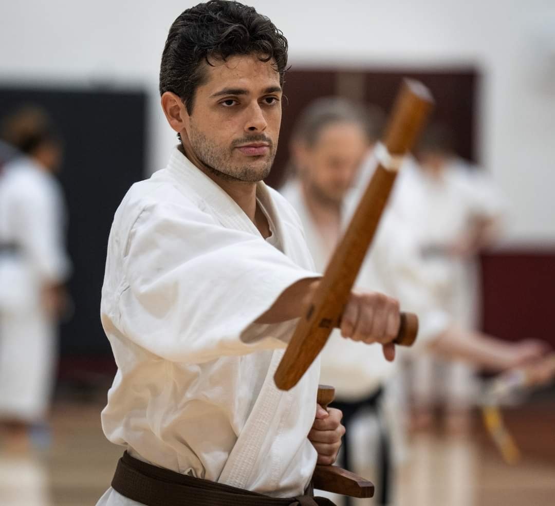 Instructor practicing Ryukyu Kobudo with traditional Okinawan weapons
