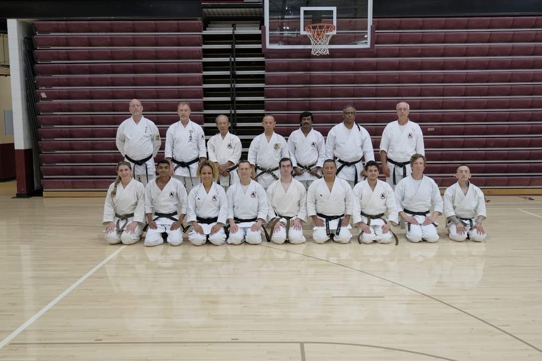 Group photo of Ryukyu Kobudo practitioners and senior masters